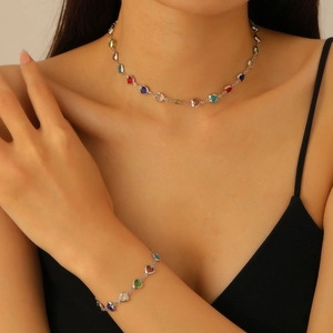 Detail of colorful heart-shaped gemstone necklace and bracelet set on a model