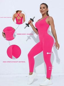 Detail of pink ribbed yoga bodysuit featuring criss-cross back and high-stretch fabric texture