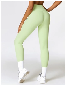 Detail of high-waist mint green yoga leggings featuring tummy control and butt lift design