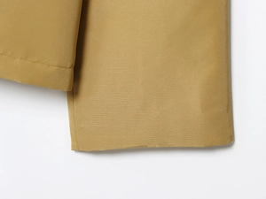 Detailed macro view of khaki woven fabric texture and stitching on trench coat cuff