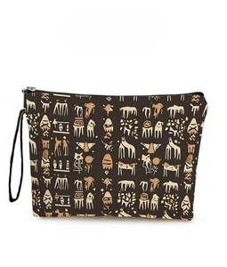 Detail view of ethnic totem print cosmetic bag with secure zipper and wrist strap