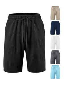 Detail of waffle textured fabric and elastic drawstring waist on men's striped casual shorts