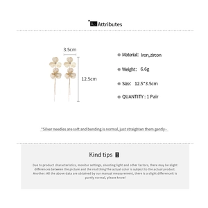 Detail view of gold flower tassel earrings with iron zircon material and size dimensions