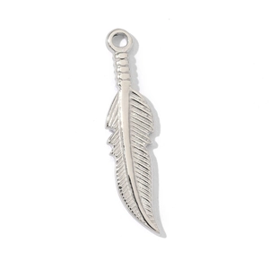 Macro shot of a silver feather-shaped stainless steel pendant with realistic texture
