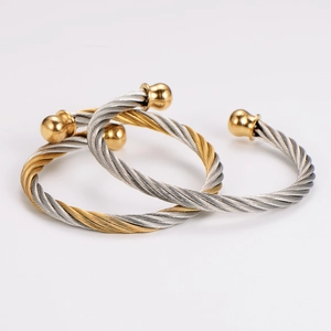 Macro detail of stainless steel twisted cable bracelet with polished spherical ends