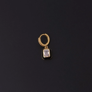 Detail of gold huggie earring with black rectangular enamel pendant and clear zircon stone