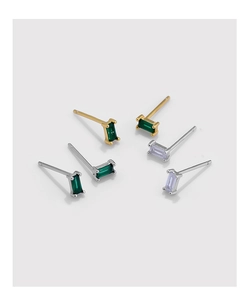 Macro shot of rectangular zircon stud earrings in gold and silver plating
