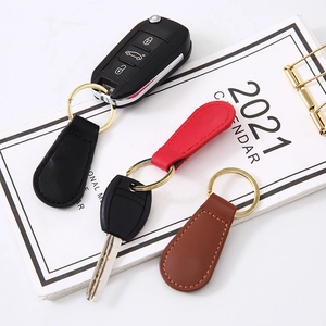 Creative PU leather magnetic keychain set in black, red and brown with gold metal rings