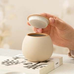 Beige ceramic airtight tea canister with matte finish and secure fabric seal lid