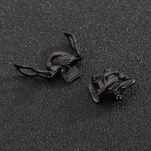 Polished black stainless steel Cuban chain clasp connector set on a dark textured surface