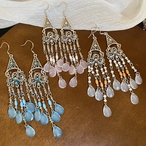 Detailed arrangement of Bohemian triangle hollow earrings with colorful crystal tassels