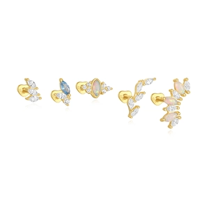 Detail view of five gold S925 silver stud earrings featuring opal and blue stones