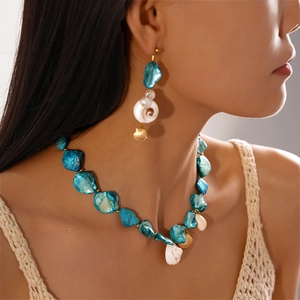 Blue ocean-themed stainless steel necklace and shell earring set on model