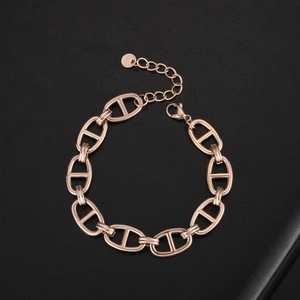 Detailed macro view of 18k rose gold pig nose link chain with secure lobster clasp