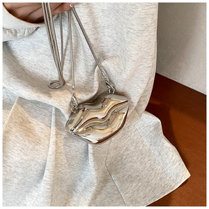 Detail shot of mini silver lip-shaped zinc alloy bag with a sleek snake chain