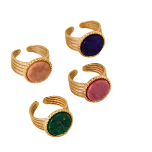 Polished gold multi-layer open rings set with colorful round natural stones on white backdrop