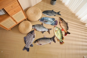Detailed 3D printed plush fish pillows including carp and crucian on wooden floor