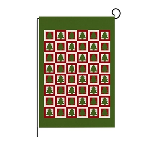 Close-up of double-sided Christmas garden flag showing linen texture and festive tree pattern