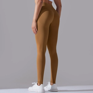 Close-up of seamless brown yoga leggings with vertical ribbed texture and peach lift design
