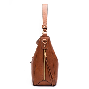 Detailed side view of brown leather shoulder bag with golden zipper and pebble texture