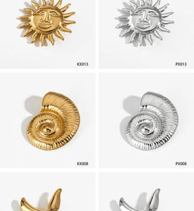 Detailed macro view of golden and silver sun-face and nautilus-shaped metal brooches