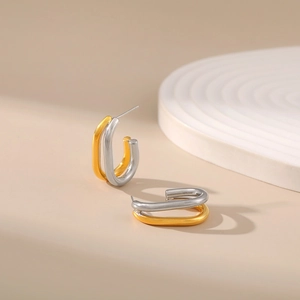 Irregular C-shaped two-tone gold and silver earrings in minimalist geometric design