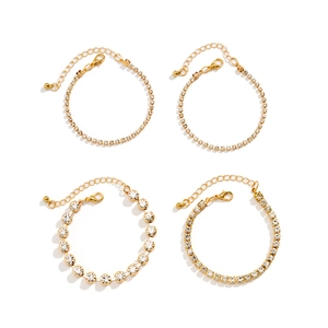 Detail view of four-piece gold bracelet set with rhinestones and lobster clasp