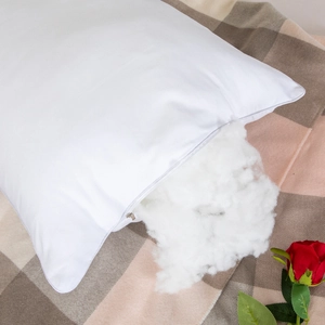 White five-star hotel pillow with zipper showing fluffy interior on a textured background