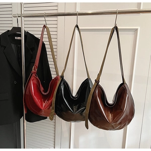 Three glossy PU leather Hobo shoulder bags in red, black, and brown with adjustable straps