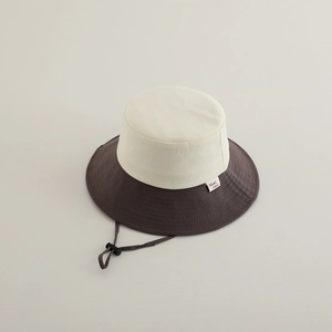 Detail view of contrast color sun hat with reinforced stitching and adjustable wind cord