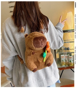 Detail of plush capybara backpack with soft brown fur and decorative orange flower