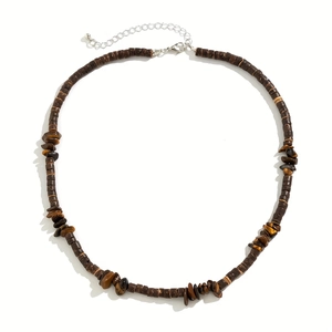 Close-up of bohemian coconut shell and tiger eye stone beads on this handmade necklace