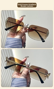 Detail of rimless butterfly sunglasses with gold temples and gradient brown lenses