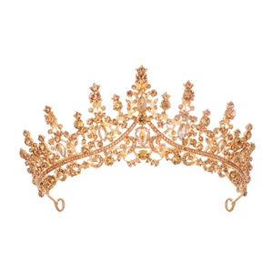 Detailed view of the gold crown hairpiece featuring intricate amber crystals and rhinestones