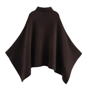 Close-up of chocolate brown knit poncho featuring a high neck and asymmetric hem texture