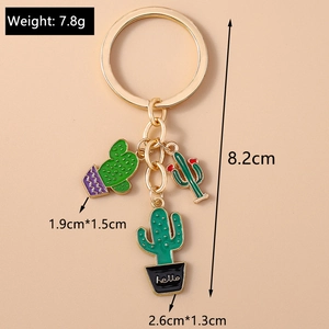Detail view of enamel cactus keychain measuring 8.2cm with hello engraved charm