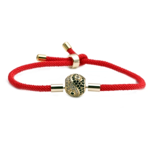 Adjustable red braided rope bracelet with golden yin yang bead and inlaid micro gems