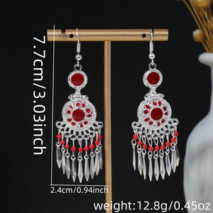 Detail view of retro silver and red tassel earrings with 7.7cm height measurements