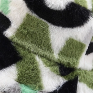 Close-up of soft camouflage faux fur texture on a warm winter bucket hat for women