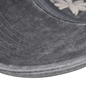 Macro detail of washed cotton fabric with six-row stitching on gray baseball cap brim