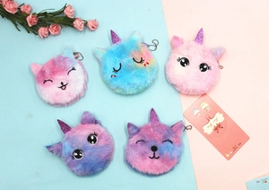 Macro view of plush unicorn coin purses with gradient fur and embroidered facial details