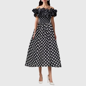 Detailed view of polka dot off-shoulder dress with ruffled neckline and flared skirt
