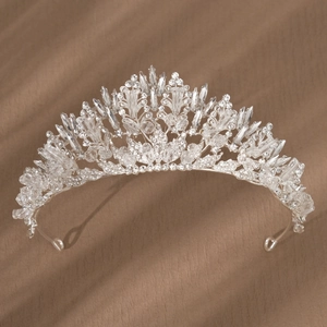 Detailed macro view of silver bridal crown with glittering crystals and floral alloy patterns