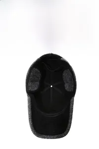Detail view of winter flat cap with ear flaps and thick warm inner lining