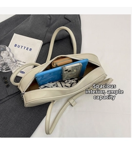Interior view of cream baguette bag showing storage for phone, wallet and accessories