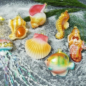 Marine theme ocean animal glass painted Christmas ornaments on snowy background scene