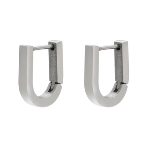 Close-up of geometric U-shaped silver stainless steel earrings with a brushed matte finish