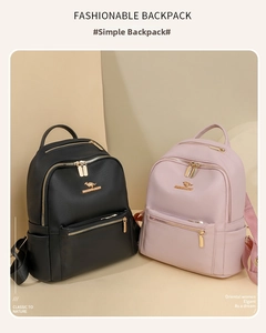 Detail of vintage faux leather backpacks in black and pink with golden logo and side pockets