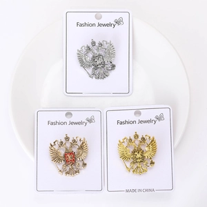 Detailed view of three vintage eagle totem brooches in silver and gold alloy finish