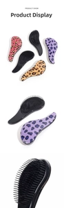 Detail view of ergonomic detangling brush with leopard print and high-elastic bristles